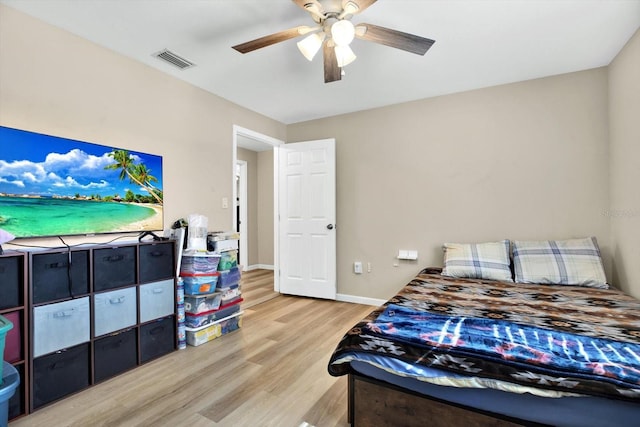 bedroom with ceiling fan and light hardwood / wood-style flooring