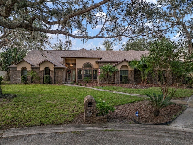 ranch-style home featuring a front yard