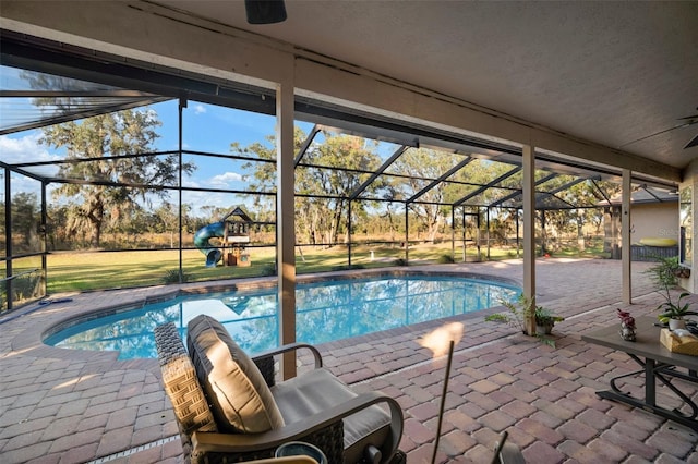 view of pool with a patio and glass enclosure