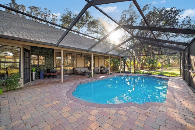 view of swimming pool with a patio, ceiling fan, and a lanai