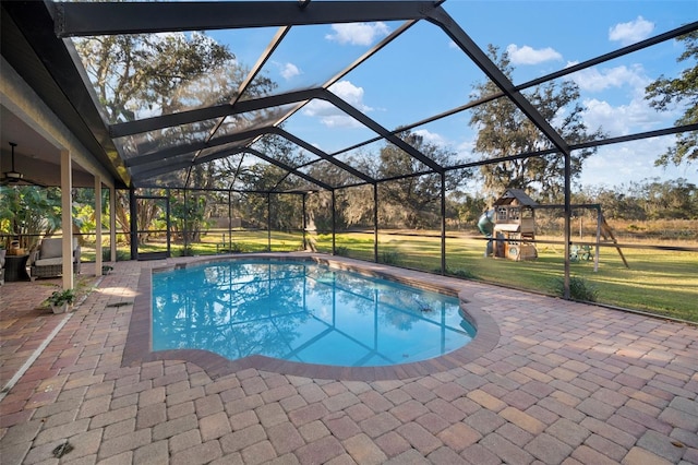 view of swimming pool featuring glass enclosure, a playground, a yard, and a patio