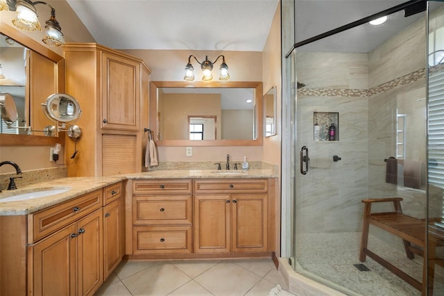 bathroom with tile patterned floors, vanity, an enclosed shower, and a textured ceiling