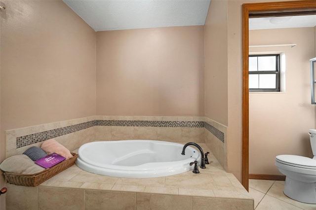 bathroom with tile patterned flooring, toilet, a textured ceiling, and tiled bath