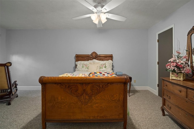 bedroom with a textured ceiling, light colored carpet, and ceiling fan