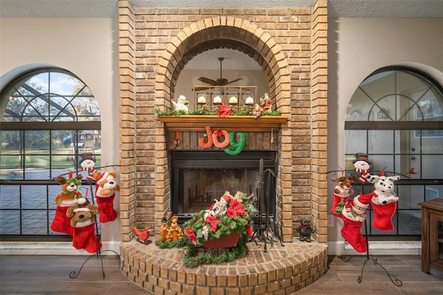 room details featuring a fireplace, hardwood / wood-style flooring, and ceiling fan