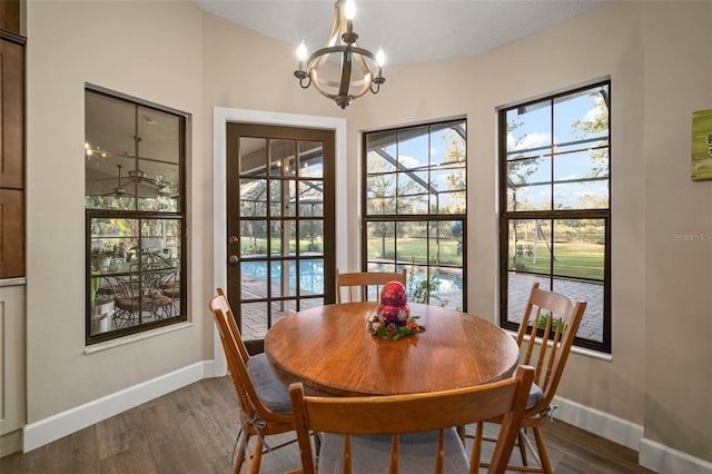 dining space featuring dark hardwood / wood-style flooring and a chandelier