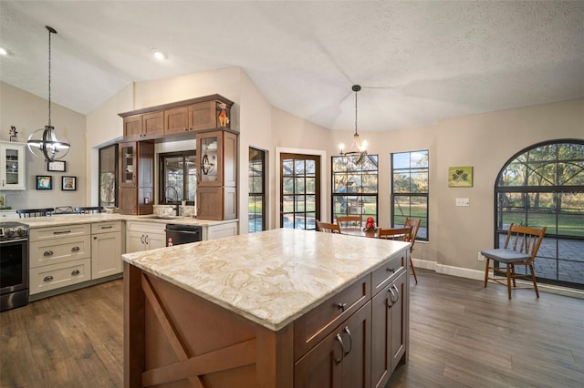 kitchen featuring pendant lighting, dark hardwood / wood-style flooring, a textured ceiling, and vaulted ceiling