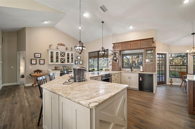 kitchen featuring dark hardwood / wood-style flooring, dishwasher, and a kitchen island