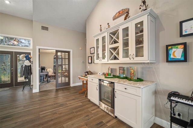 bar featuring white cabinetry, dark wood-type flooring, beverage cooler, and french doors