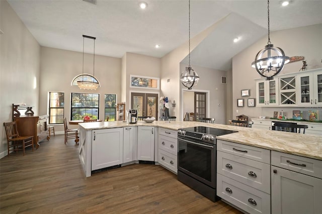 kitchen with stainless steel electric range oven, french doors, light stone counters, dark hardwood / wood-style floors, and white cabinets