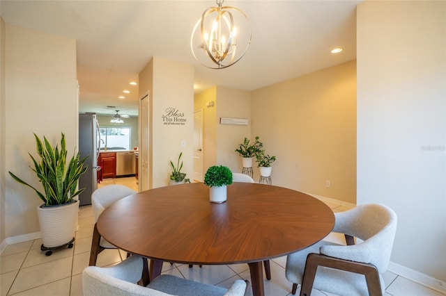 tiled dining area featuring ceiling fan with notable chandelier