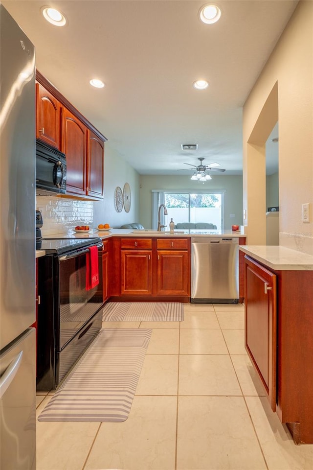 kitchen with black appliances, sink, ceiling fan, decorative backsplash, and light tile patterned floors