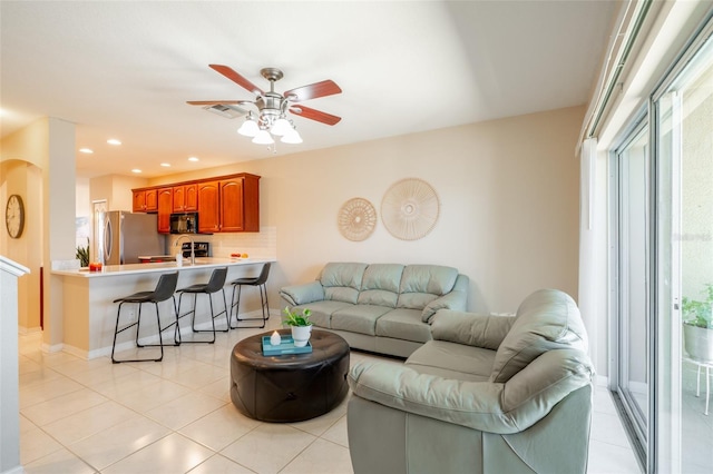 living room featuring ceiling fan and light tile patterned flooring