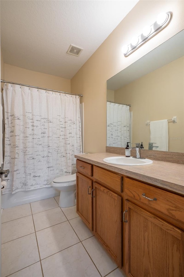 full bathroom featuring tile patterned flooring, vanity, shower / bath combination with curtain, and toilet