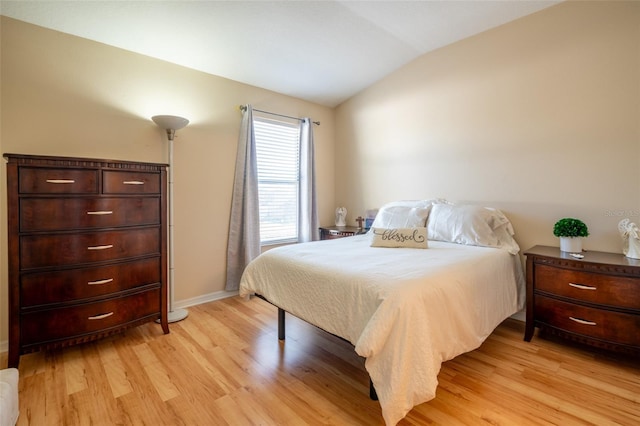 bedroom featuring vaulted ceiling and light hardwood / wood-style flooring