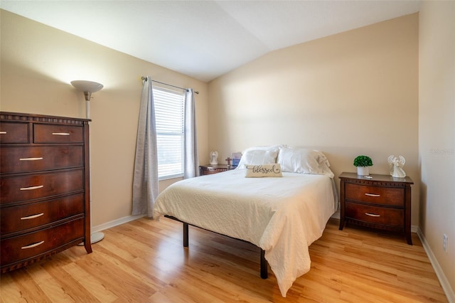 bedroom with light hardwood / wood-style floors and vaulted ceiling