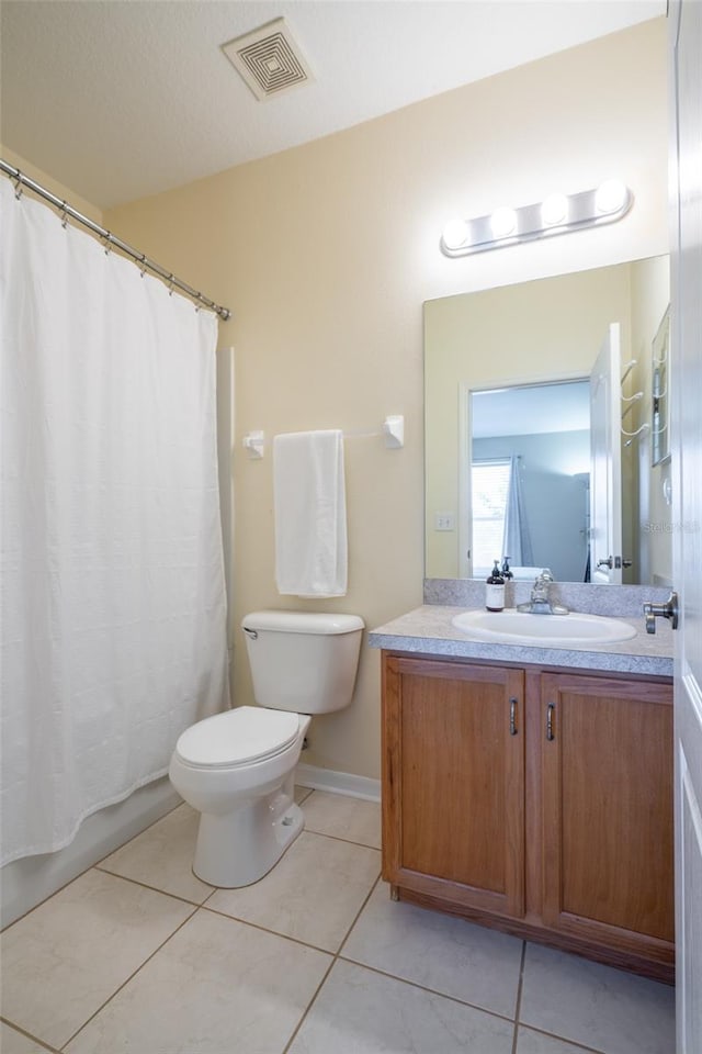 bathroom with toilet, vanity, tile patterned floors, and curtained shower