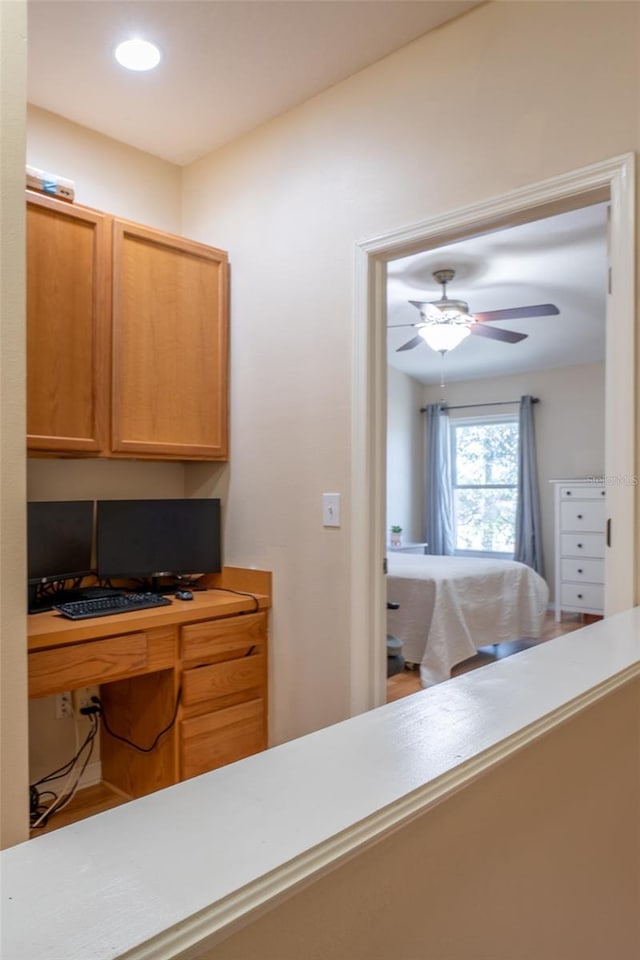 interior space with ceiling fan