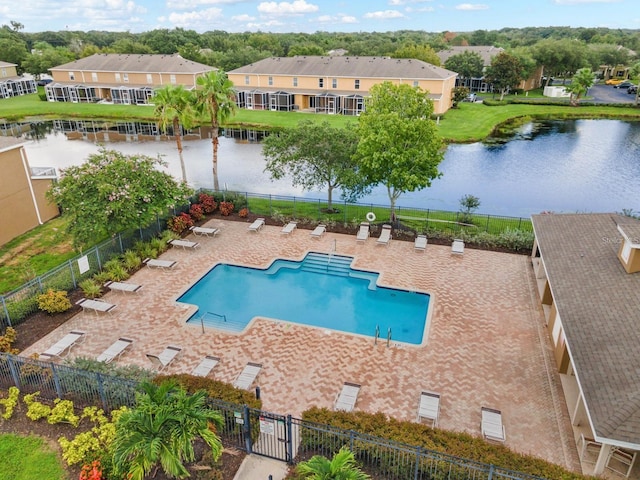 view of pool featuring a patio area and a water view