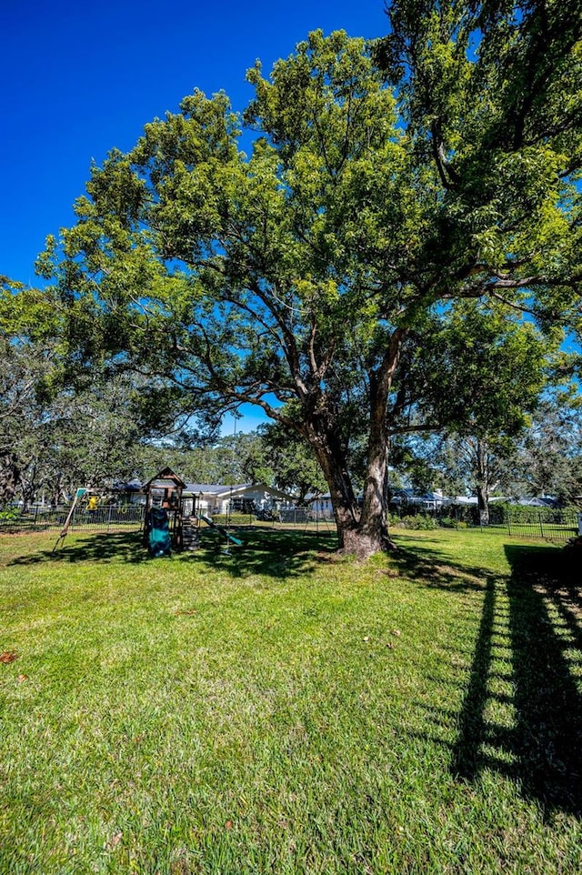 view of yard with playground community and fence