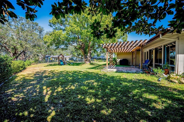 view of yard featuring a fenced backyard, a pergola, a playground, and a patio