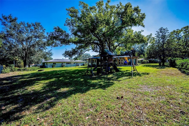 view of yard with playground community and fence