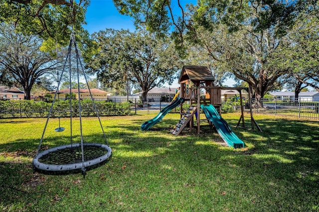 community play area featuring fence and a lawn