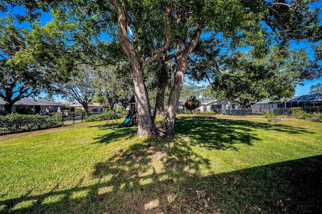 view of yard with a residential view, playground community, and fence