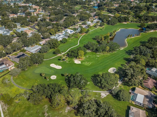 drone / aerial view with a water view, a residential view, and golf course view