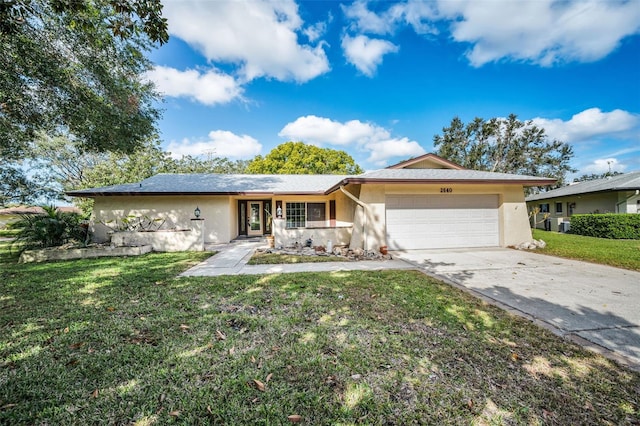 ranch-style home featuring a garage, driveway, a front lawn, and stucco siding