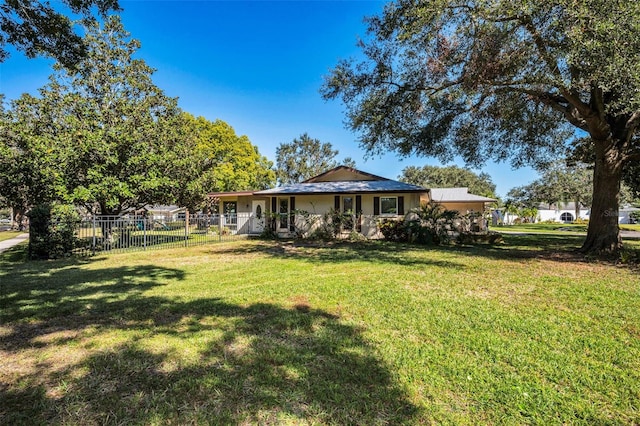 view of front facade with a front yard and fence