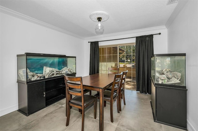 dining area featuring baseboards, ornamental molding, concrete flooring, and a textured ceiling