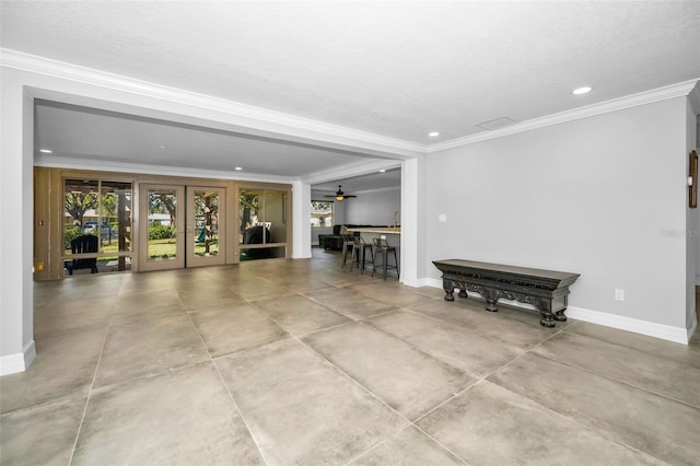 living room featuring french doors, ornamental molding, and baseboards