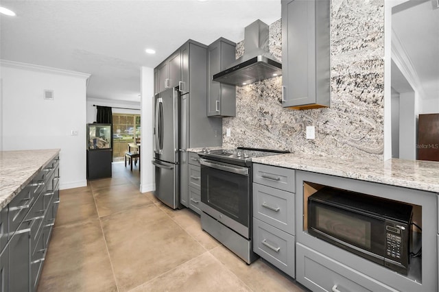 kitchen featuring wall chimney exhaust hood, tasteful backsplash, gray cabinets, and stainless steel appliances