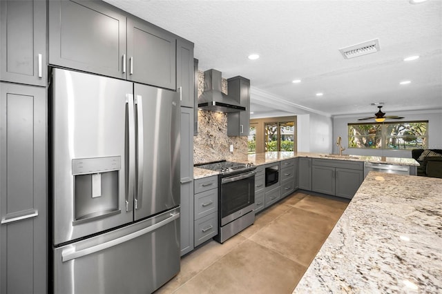 kitchen featuring stainless steel appliances, tasteful backsplash, visible vents, gray cabinetry, and wall chimney range hood