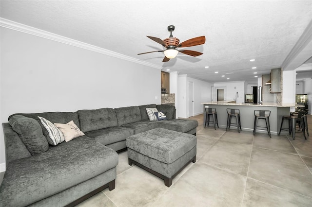 living room with crown molding, recessed lighting, a ceiling fan, a textured ceiling, and concrete floors