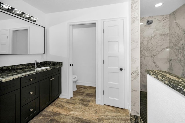 full bathroom featuring a marble finish shower, vanity, toilet, and recessed lighting