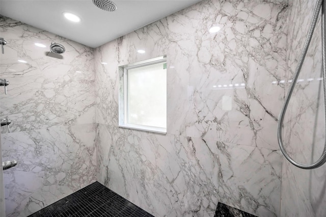 bathroom with visible vents and a marble finish shower