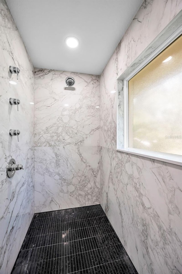 bathroom with a marble finish shower