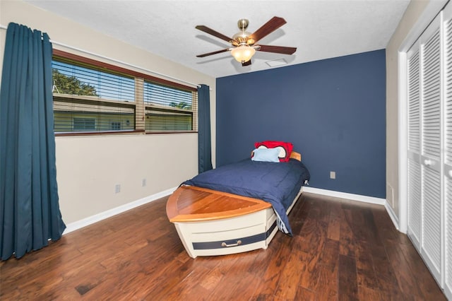 bedroom with multiple windows, baseboards, and dark wood-type flooring