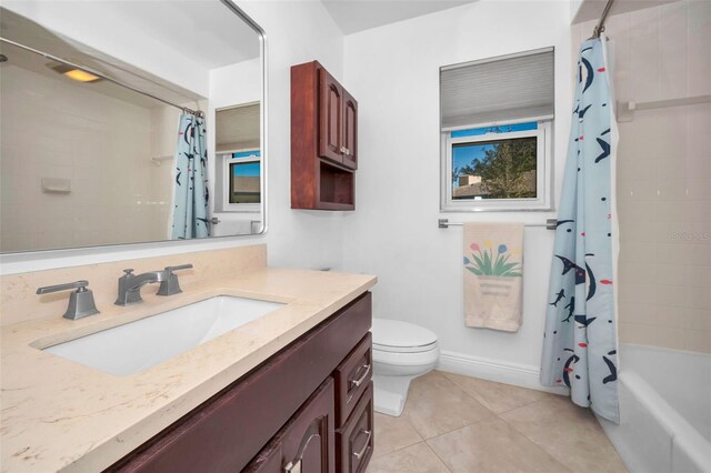 bathroom featuring toilet, shower / bathtub combination with curtain, vanity, and tile patterned floors