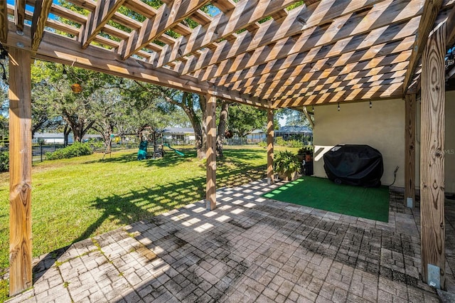 view of patio featuring grilling area, a playground, fence, and a pergola