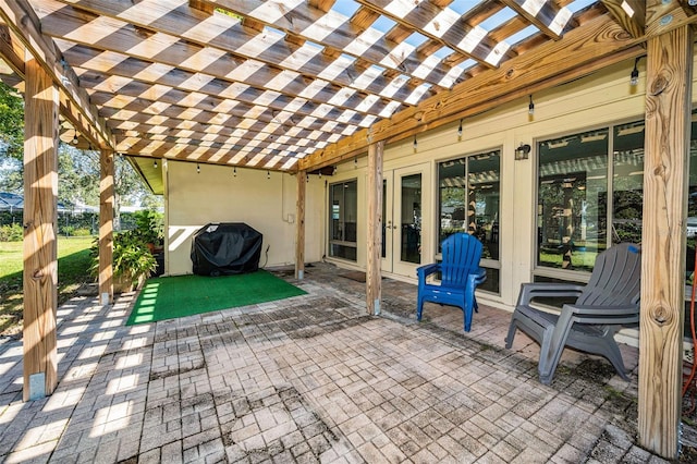 view of patio / terrace with grilling area and a pergola