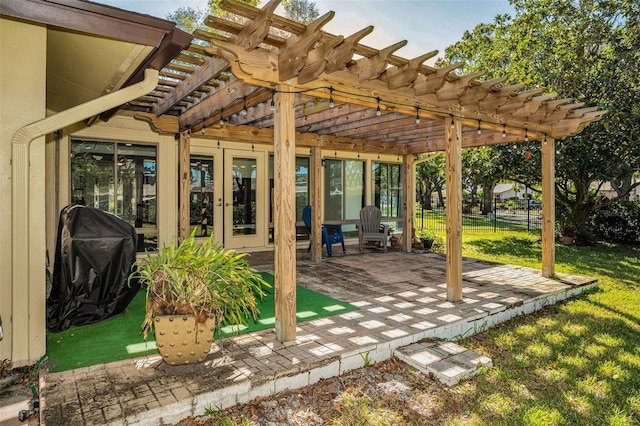 view of patio with fence, area for grilling, and a pergola