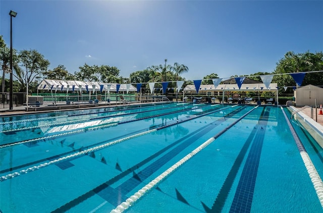 view of swimming pool featuring fence