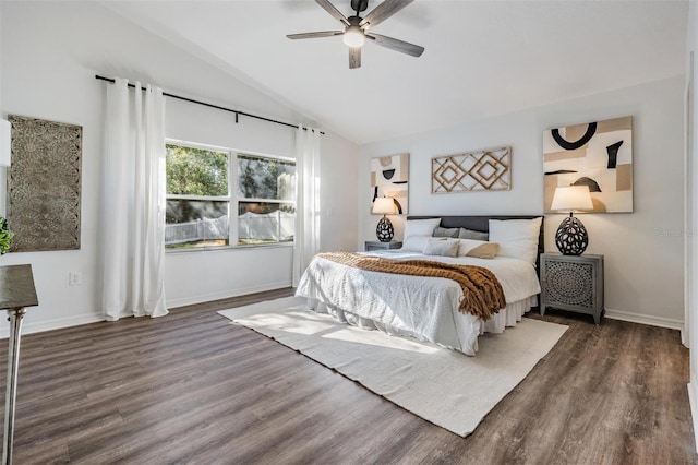 bedroom with ceiling fan, dark wood-type flooring, and vaulted ceiling