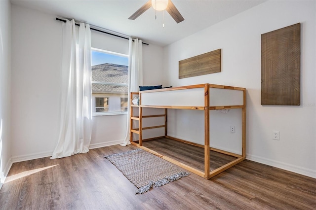 unfurnished bedroom with baseboards and wood finished floors