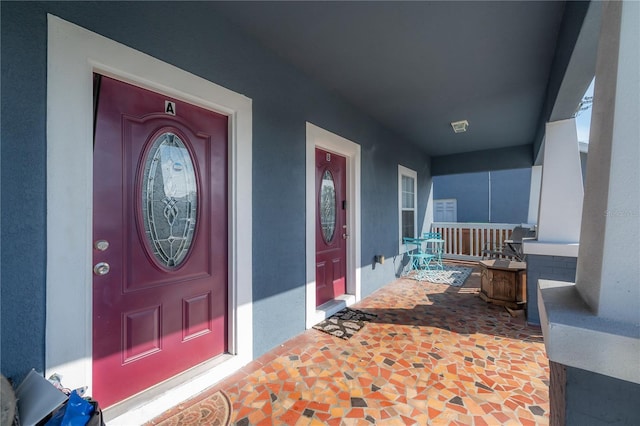 view of exterior entry with covered porch