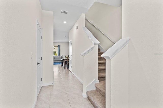 stairway featuring tile patterned floors