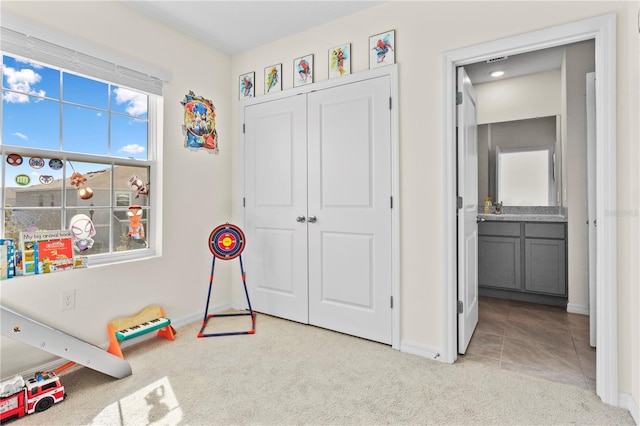 game room with light colored carpet